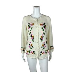 "Vintage 60s Floral Cardigan Embroidered Cream Multi Color Acrylic Sweater LABEL: Glamour Knits Fully Fashioned, Made in Taiwan FABRIC: 100% Acrylic MARKED VINTAGE SIZE: - SLEEVE LENGTH: 17\" underarm to end of sleeve BUST: 40\" WAIST: 38\" LENGTH: 24\" CONDITION: great, see photos- green thread popping out on back, loop sticking out of hem, loose purple thread on front PINNED TO MODEL?: no ☝For reference Mod's measurements are S 11\", B 32.5\", W 24\", H 32.5\"☝ ♪ Wanna dress you up in vintage, all over, all over! ♪ https://www.etsy.com/shop/StorylandVintage Ps. Follow @StorylandVintage on IG for sneaky peeks at vintage before it hits the shop!" Winter Floral Embroidered Crew Neck Cardigan, Winter Floral Embroidery Crew Neck Cardigan, Winter Cardigan With Floral Embroidery And Crew Neck, Cream Embroidered Winter Cardigan, Winter Embroidered Cream Cardigan, Winter Crew Neck Cardigan With Floral Embroidery, Embroidered Cream Cardigan For Winter, Embroidered White Cardigan For Winter, Winter Cream Embroidered Cardigan