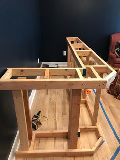 a workbench is being built in the middle of a room with hard wood flooring