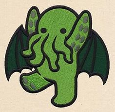 an embroidered patch with an image of a green creature in the shape of a bat