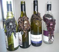 four bottles of wine with designs on them