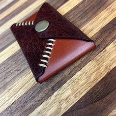 a brown leather wallet sitting on top of a wooden table