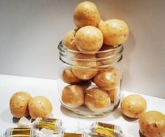 a glass jar filled with potatoes next to some candy