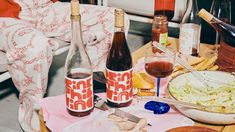 a table topped with bottles of wine and food