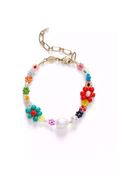 a bracelet with colorful beads and flowers on the clasp is shown against a white background