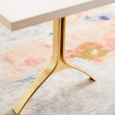 a close up of a table on a carpet with a rug in the back ground