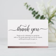 a thank card with the words, thank you on it and a bouquet of flowers in the background