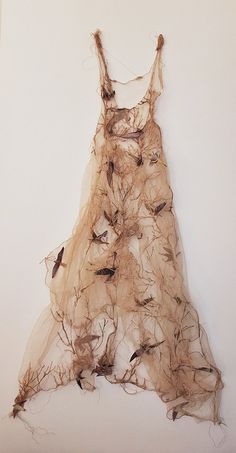 a dress made out of branches with birds on it