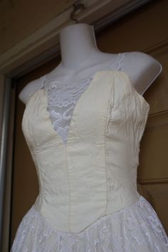 "Stepping Out 1980s party dress. Small - see measurements., Boned bodice. Zips and ties in the back. Overall good vintage condition but could use pressing - off white from age. Made by Stepping Out Measurements taken across front lying flat 16\" across front armpit to armpit 13\" across front of waist 37\" length armpit to bottom" Fitted Bodice For Spring Wedding, Fitted Wedding Bodice For Spring, Spring Wedding Fitted Bodice, Summer Wedding Bodice With Corset Back, Cream Corset Dress With Fitted Bodice For Parties, Fitted Lace Trim Corset Dress For Prom, Summer Evening Bodice With Boned Structure, Fitted Lace Bodice, Vintage Corset With Corset Back For Party