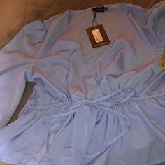 Pretty Little Thing Long Sleeves Blue Blouse In Us Size 16. It Has An Adjustable Waist And Elastic At The End Of The Sleeves. Material Is A 100% Polyester Aprox Measurements Laying Flat Pit To Pit 23 1/2” Length From Neck To Hem 26 1/2” Waist. 24” (Adjustable) 24”Would Be The Max Without Adjustment Sleeves Length 27 1/2” Smoke Free Home Trendy Light Blue V-neck Blouse, Light Blue Long Sleeve Blouse For Brunch, Blue V-neck Blouse For Brunch, Elegant Light Blue Tops For Night Out, Elegant Light Blue Top For Night Out, Light Blue Long Sleeve Blouse For Day Out, Blue V-neck Blouse For Day Out, Blue V-neck Blouse For Party, Light Blue Casual Blouse For Party