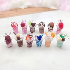 a group of miniature ice cream sundaes sitting on top of a white table