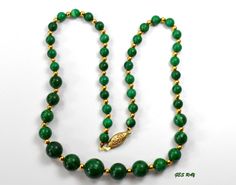 "Estate Graduated & Polished Genuine Malachite Bead with gold plated spacers necklace. The necklace is approximately 18.5\" long. The largest bead is approximately 3/8\" in diameter and the beads are going smaller from the middle to the East and West. total weight - 1.1 oz.It has a slip in clasp. It is a vintage item in very good condition. Please see enlarged pictures for a detailed view. All returns must be postmarked within 7 days from the date you received the item. All sales are final a Gold Spiritual Emerald Necklace With Round Beads, Gold Emerald Necklace With Round Beads And Spiritual Style, Formal Gold Hand-strung Beaded Necklaces, Hand-strung Gold Emerald Necklace Gift, Gold Emerald Necklace With Round Beads Single Strand, Gold Emerald Necklace With Round Beads, Peacock Pendant, Vintage Gothic, Glass Pendant Necklace