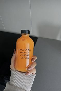 a woman holding an orange juice in her left hand with the words pay per bottle on it