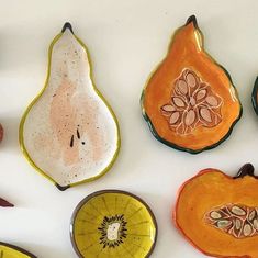 several pieces of fruit are arranged on a white surface