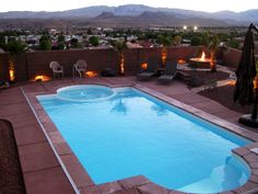 an empty swimming pool surrounded by patio furniture