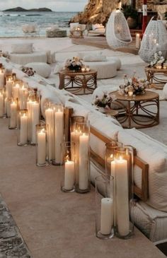 candles are lined up along the edge of an outdoor seating area