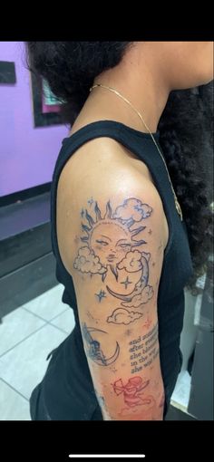 a woman with a sun and clouds tattoo on her arm