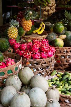 many different types of fruits and vegetables in baskets