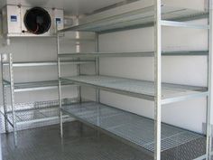 the inside of a storage room with shelves and an air conditioner on the wall