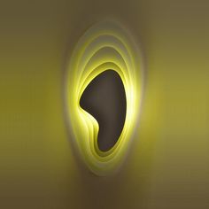 a yellow light is shining on a wall with an abstract shape in the center,