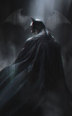 a batman standing in the dark with his cape open