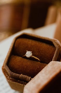 an engagement ring sitting in a box on top of a table