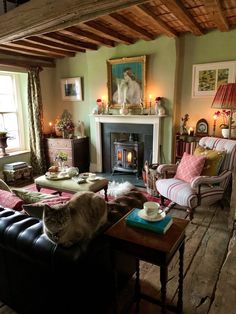 a living room filled with furniture and a fire place next to a painting on the wall