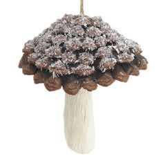 a white vase filled with cookies covered in powdered sugar on top of a wooden stick