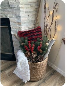 a basket filled with pine cones and other holiday decorations next to a fire place mantle