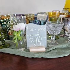 a table topped with lots of glasses and vases