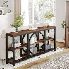 a living room filled with furniture and a large mirror on top of a wooden table