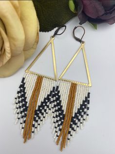 the earrings are made with seed beads and gold triangles