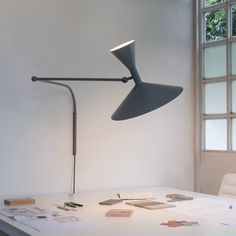 a desk lamp sitting on top of a white table