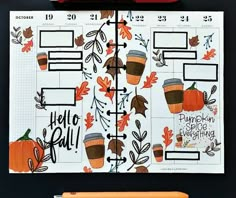 a planner with coffee cups and leaves on it, next to an orange marker that says hello fall