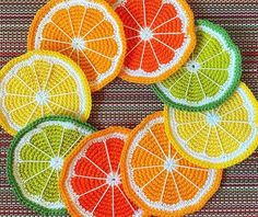 crocheted fruit coasters with slices of orange, lemon and grapefruit