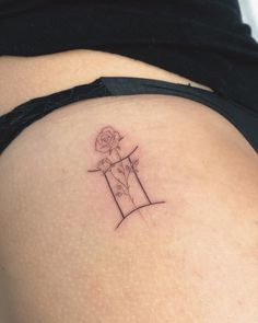 a woman's stomach with a rose tattoo on her left side ribcage