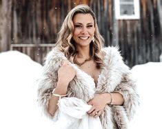 a woman wearing a fur coat in the snow