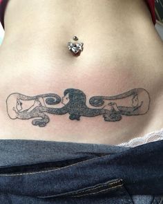 a woman's stomach with two skateboards in the shape of a dog on it