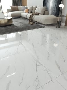 a living room with white marble floors and furniture