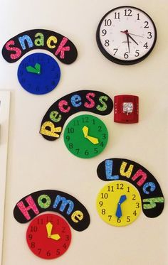 several colorful clocks on the wall with words and numbers written in different languages to spell out their time