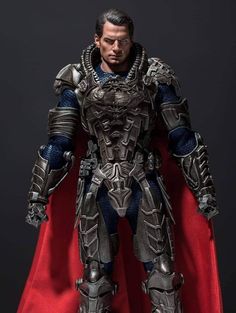 the action figure is dressed in armor and holding a red cape, with his hands on his hips