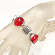 Sterling Silver & Bright Red Poured Glass Vintage Toggle Bracelet - Circles and Squares - Bold Statement - Mexico Silverworld - Link - Gift Vintage Sterling Bracelet Brand: Silverworld   Era: VINTAGE Description: - Sterling Silver - Poured Red Glass Cabochons - Toggle Clasp - Bold & Beautiful - Bright Blood Red - 44 Grams Total Weight Condition - Very Good / No Scratches or Tarnishing  Length: 7.7 INCHES / 19.5 CM  I Have Had This Question Asked A Few Times; Yes, I accept Returns. I Always Want My Customer to Be Able To Trust Me and The Items I Sell. Please Contact Me As Soon As You Can with Any Concerns You May Have with The Piece of Jewelry Once You Receive It.  -  So Buy with Confidence; I know You Will Love It - Or I'll Take It Back :) Some of my pieces are vintage with a natural patin Adjustable Red Formal Jewelry, Formal Red Metal Bracelets, Nickel-free Red Metal Bracelets, Nickel-free Red Metal Bracelet, Red Nickel-free Metal Bracelets, Red Nickel-free Metal Bracelet, Adjustable Red Bracelets For Formal Occasions, Red Fusion Jewelry For Formal Occasions, Red Bracelet With Polished Finish As Gift