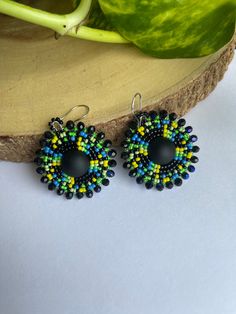 Handmade beaded earrings with kidney earring wire hooks. These are made with seed beads, for the edging I used rondelle beads. Colorful Round Beaded Earrings, Adjustable Round Czech Glass Beaded Earrings, Handmade Round Czech Glass Beaded Earrings, Adjustable Round Black Beaded Earrings, Czech Glass Beaded Earrings With Spacer Beads, Czech Glass Beaded Earrings With Ear Wire, Czech Glass Round Beaded Earrings With Ear Wire, Colorful Czech Glass Beaded Earrings, Handmade Beaded Earrings