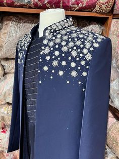 Midnight blue exclusive embellished with intricate pearl, stone, zari and cutdana work, this sherwani speaks volume of class. Commingled with blue color kurta for the complete ensemble. This jacket sherwani is a unique style that we loved. Even the color is fresh and looks royal. Size: 42,44 Occasion: Wedding Ceremony or Reception WASH CARE INSTRUCTIONS - Please Dry clean only when it is applicable. Slight color variation is possible due to digital photography. Ready to Ship! Designer Embellished Long Sleeve Sherwani, Festive Designer Sets With Pearl Embroidery, Designer Sherwani With Pearl Embroidery For Festive, Formal Kurta With Pearl Embroidery And Traditional Drape, Embellished Unstitched Sherwani For Eid, Royal Blue Bandhgala For Wedding, Royal Festive Wedding Kurta, Royal Sherwani With Zari Work For Festive Occasions, Royal Sherwani With Zari Work For Formal Occasions