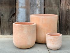 three clay pots sitting next to each other