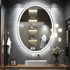 a bathroom with a round mirror above the sink and shelves on the wall next to it