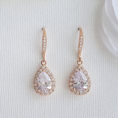 Pretty and sparkly, the Emma rose gold bridal earrings are great as simple wedding dangle earrings or bridesmaid earrings. Small Clear Cubic Zirconia detailed teardrops in a halo setting dangle from cubic zirconia detailed rose gold plated brass earwires. They are light weight and easy for all day wear. Material used is rose gold plated brass. I also have them available in silver/rhodium finish and 14k gold finish. Also available with a matching necklace. # length of Earring from top is approx 1 Wedding Bridal Earrings In Rose Gold With Halo Design, Elegant Rose Gold Teardrop Earrings For Wedding, Elegant Rose Gold Teardrop Earrings For Anniversary, Rose Gold Halo Bridal Earrings For Wedding, Rose Gold Drop Bridal Earrings For Formal Occasions, Bridal Drop Earrings With Halo Design, Classic Rose Gold Bridal Earrings For Wedding, Elegant Rose Gold Teardrop Bridal Earrings, Sparkling Rose Gold Earrings For Wedding