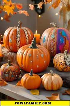 several pumpkins are sitting on a table with candles