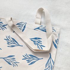 a white bag with blue leaves on it