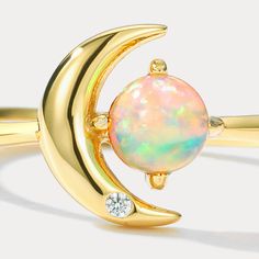 This exquisite Moon Star Opal Ring is the perfect statement piece for any occasion. Crafted from the highest quality materials and featuring a prominent opal centrepiece, this ring is sure to make you stand out from the crowd in style. An ideal gift for yourself or a loved one, it’s sure to become a cornerstone of your wardrobe. DETAILS Plating: 10K Gold Materials: 10K Gold on   Silver,   Cubic Zirconia,   Opal Size: Adjustable Weight: 1.4g Luxury Celestial Opal Ring For Anniversary, Sun Ring With Opal, Sun Ring Opal, Luxury White Opal Celestial Ring, Luxury Celestial Opal Ring, Star And Moon Necklace, Astrology Jewelry, Fire Opals Jewelry, Rabbit Earrings