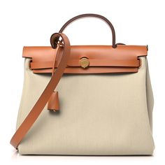 This is an authentic HERMES Military Toile Vache Hunter Herbag Zip Retourne 31 PM in Beton and Naturel. This bag is crafted of sturdy beige toile canvas and features a light brown leather top crest with a leather top handle, shoulder strap and a rear exterior zipper pocket. The front flap opens with double straps with gold hardware and a padlock. This opens to a matching canvas interior with a removable pouch. Brown Leather Top, Light Brown Leather, Birkin Bag, Leather Top, Gold Hardware, Light Brown, Top Handle, Zipper Pocket, Fashion Bags